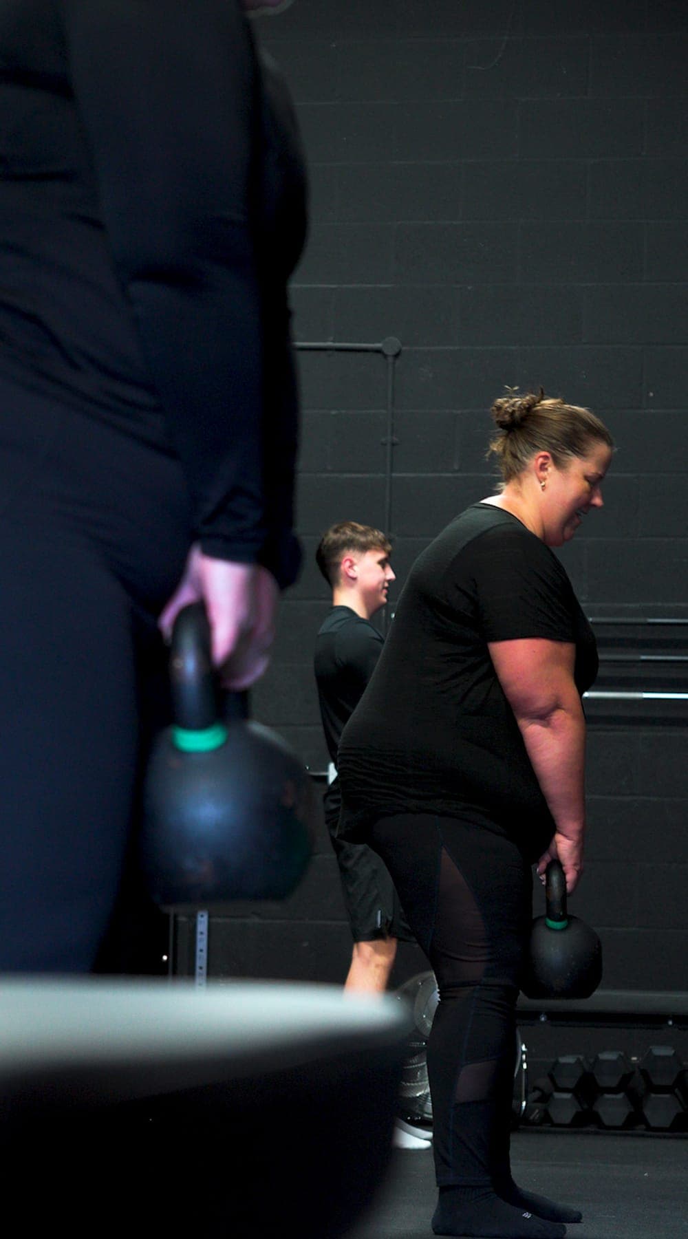 Members training in a Small Group Personal Training session while a Moai coach watches on